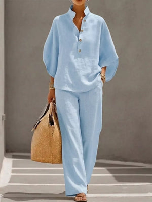 Sky blue button-down loungewear set with wide leg pants and a relaxed fit top.