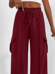 Burgundy high waist cargo sweatpants with drawstring and side pockets.