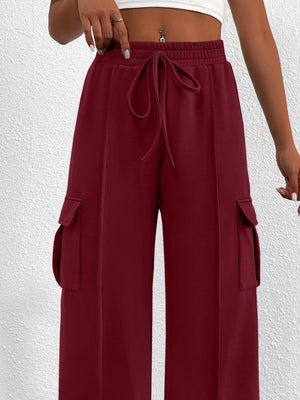 Burgundy high waist cargo sweatpants with drawstring and side pockets.