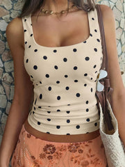 Apricot polka dot scoop neck tank top with a cropped fit.