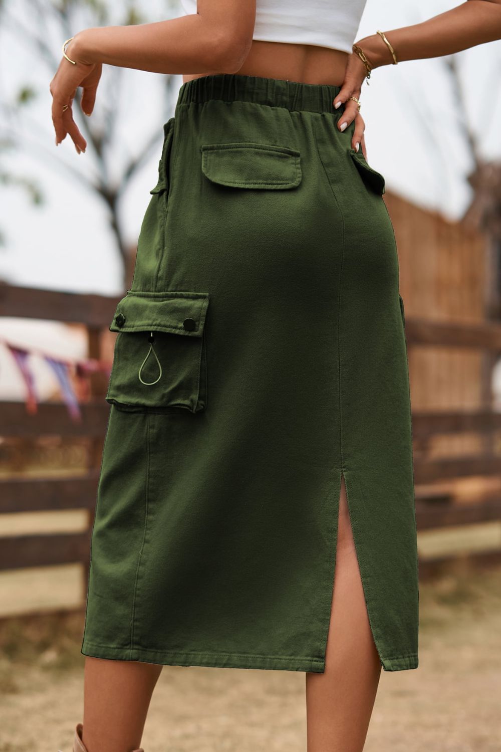 Army green midi skirt with drawstring waist and utility pockets, featuring a side slit.