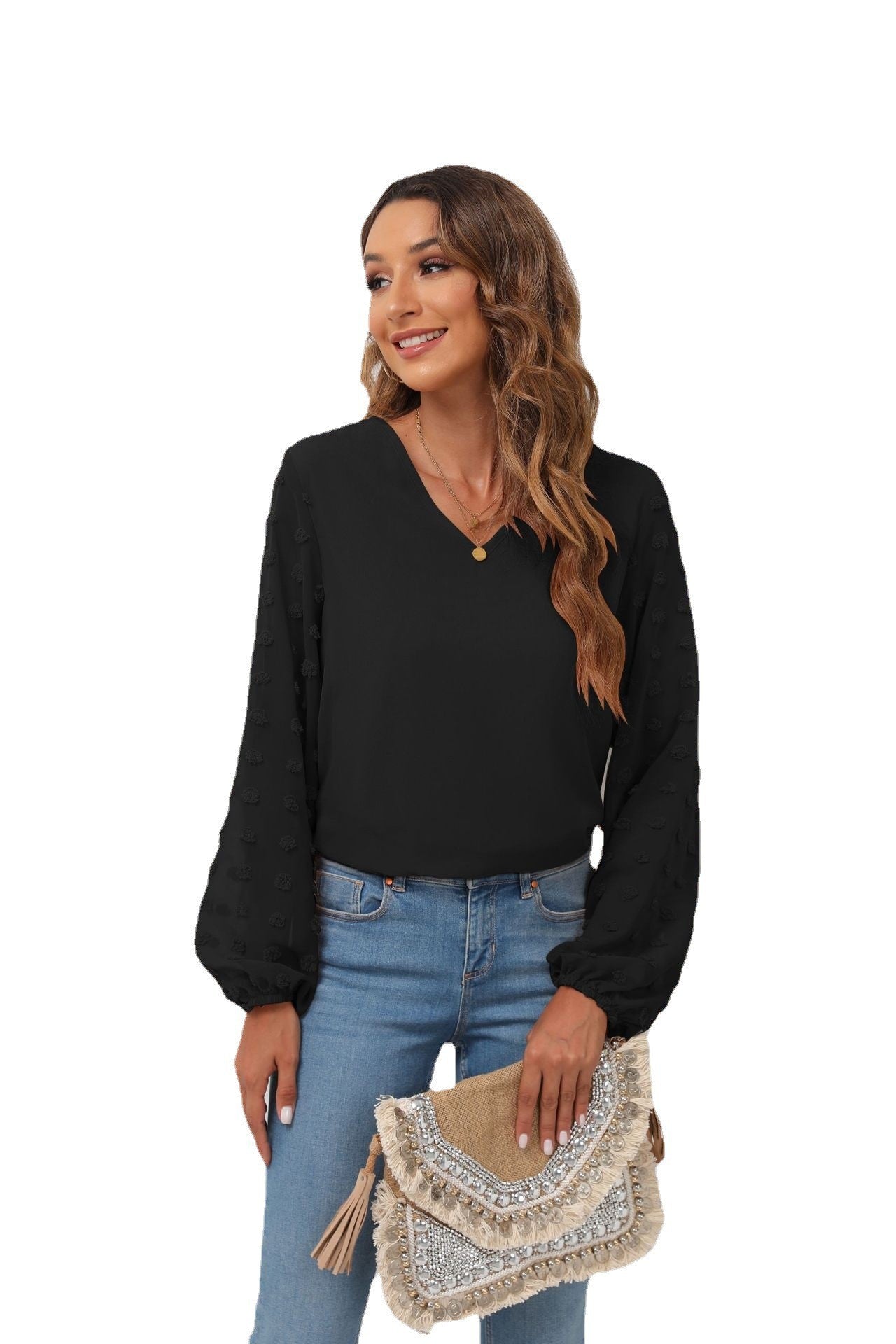 Black V-neck blouse with pom-pom textured balloon sleeves.