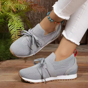 Gray knit & suede lace-up sneakers with white soles and a red heel tab.