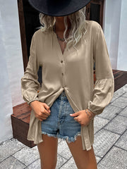 Oversized khaki blouse with mandarin collar, button front, and balloon sleeves.