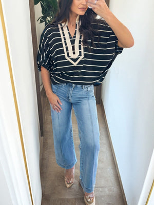 Striped dolman top with stand collar and beige trim, made of cotton.