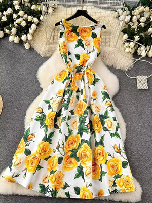 Yellow floral midi dress with pleated skirt and sleeveless design.