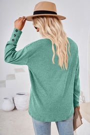 Green long sleeve top with button cuff detail