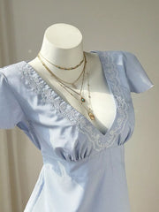 Blue striped polyester blouse with V-neck and lace trim detail