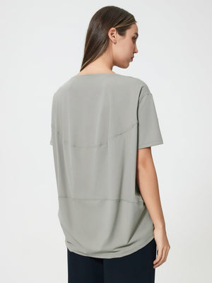 Relaxed fit performance tee in gray with seam details on back.
