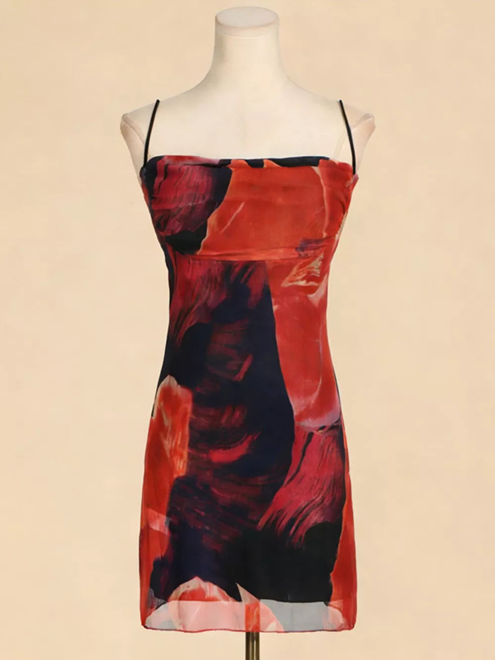 Abstract print spaghetti strap dress in red and blue, bodycon fit.