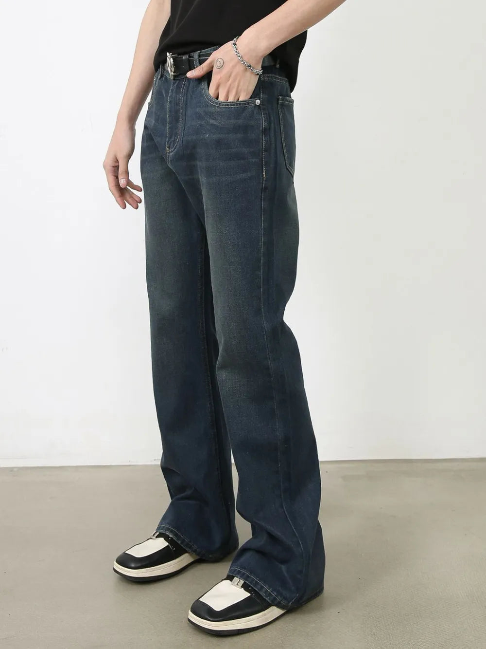 Dark wash denim flared trousers with subtle fading and bootcut leg.