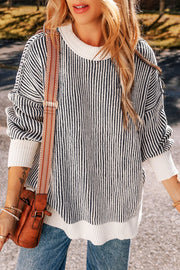 Black and white striped drop-shoulder knit sweater with a crew neck and ribbed hem.