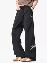 Black wide-leg drawstring pants with embroidered logo detail