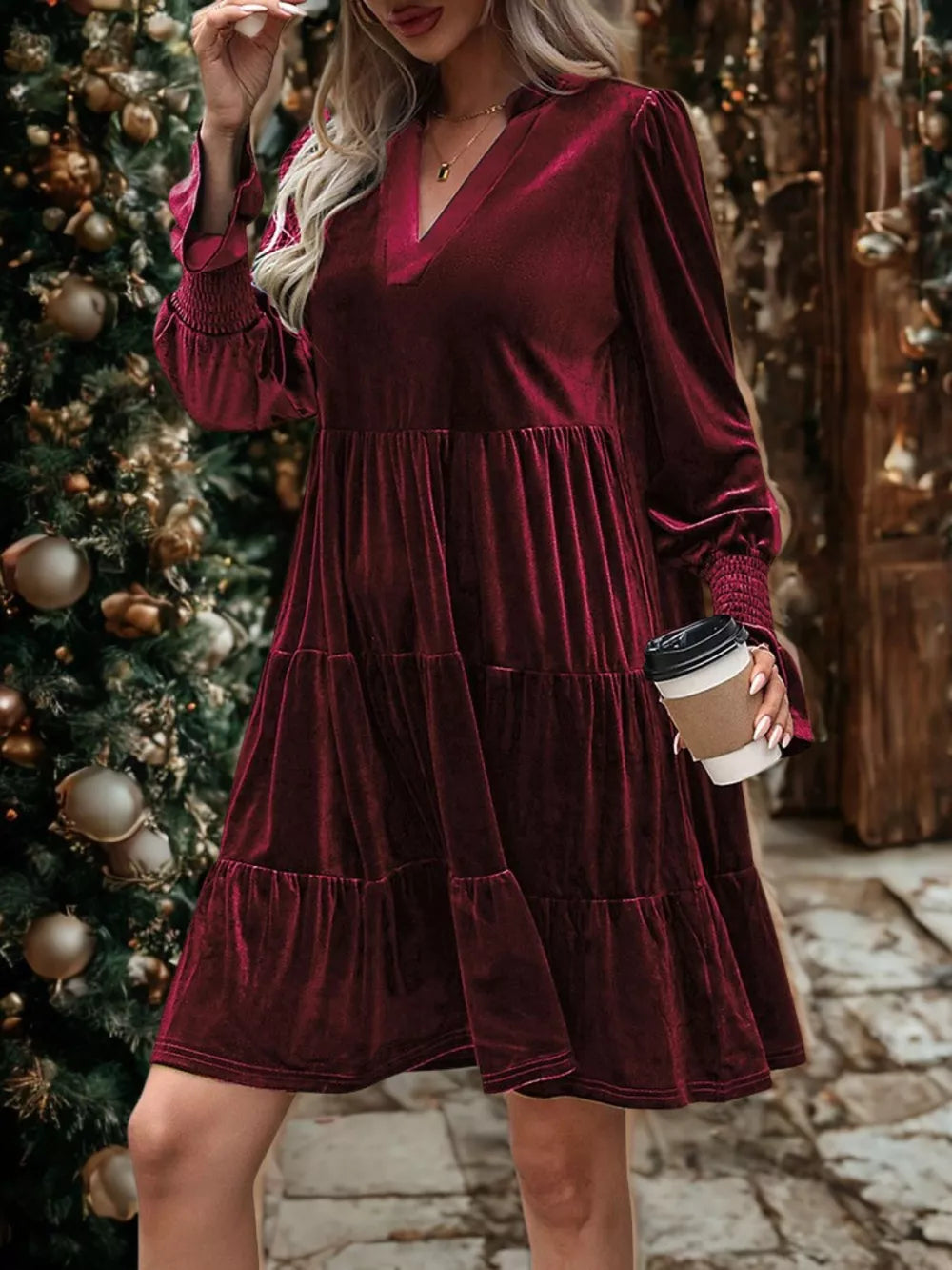 Burgundy velvet tiered mini dress with V-neck and smocked cuffs.