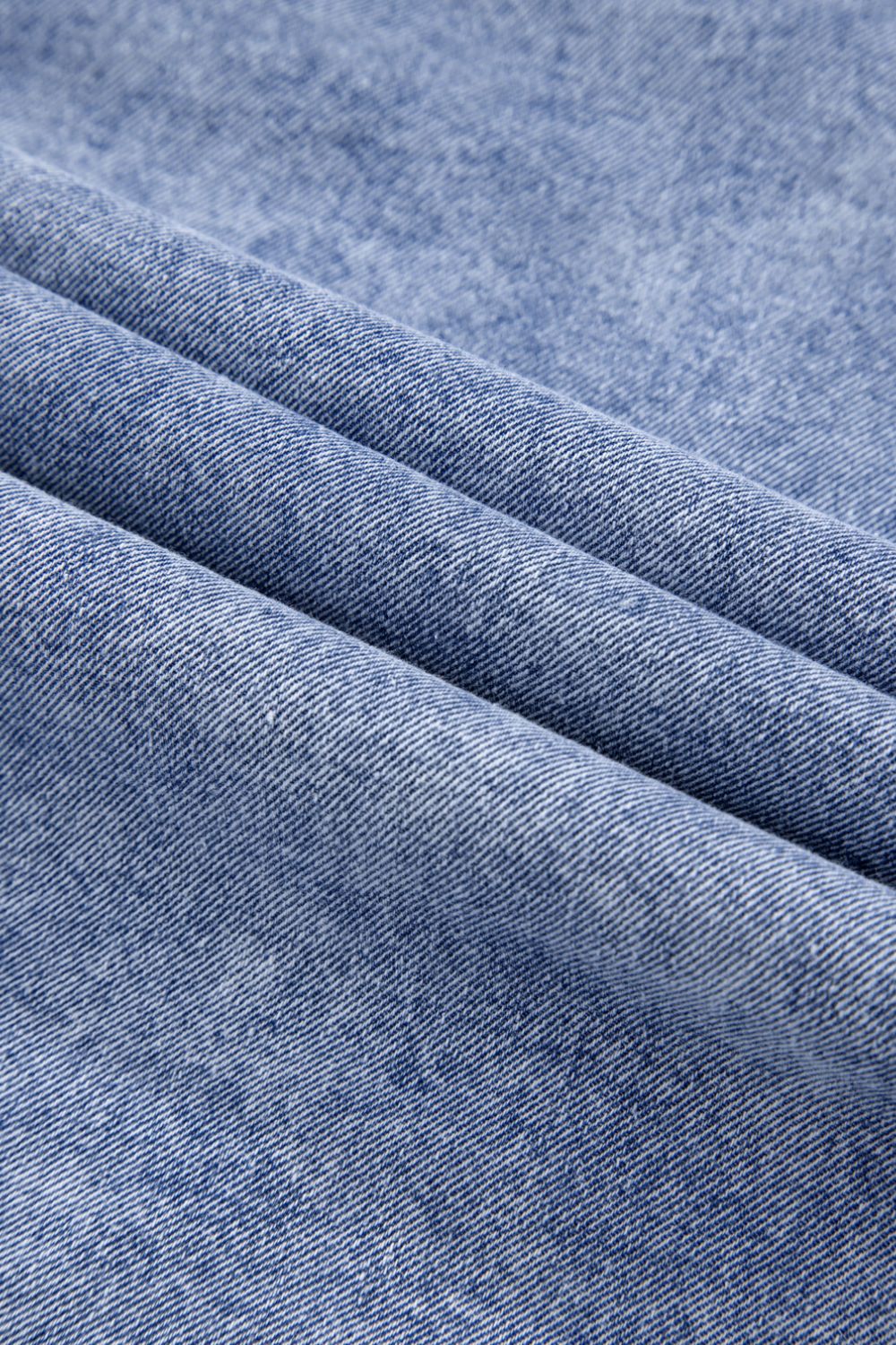 Acid wash denim shirtdress in medium, showing fabric texture and folds.
