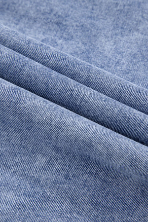Acid wash denim shirtdress in medium, showing fabric texture and folds.