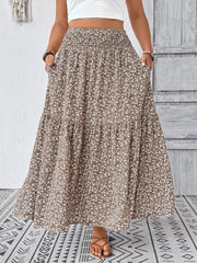 Maxi skirt in mocha with a white floral print, tiered design, and pockets.