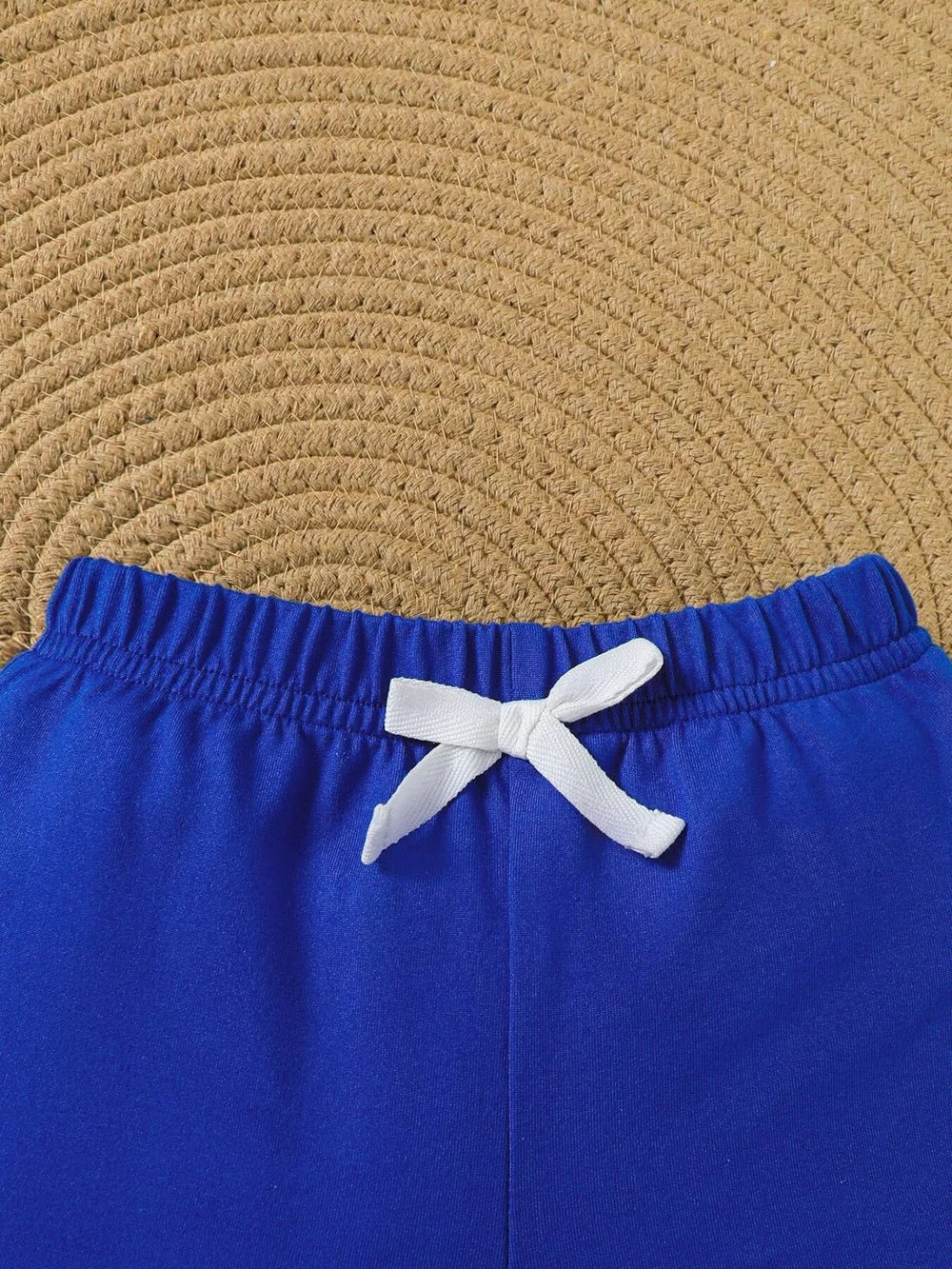 Blue baby shorts with elastic waistband and white drawstring bow detail.
