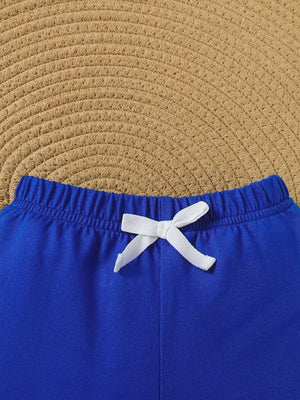 Blue baby shorts with elastic waistband and white drawstring bow detail.