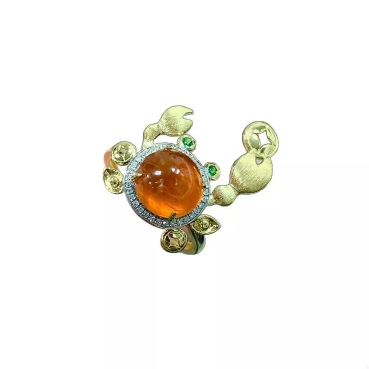 Gold crab ring with orange gemstone and green accents