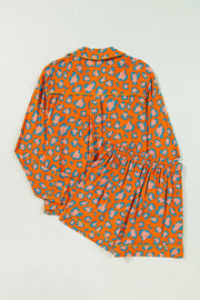Orange leopard print satin pajama set with collared top and shorts.