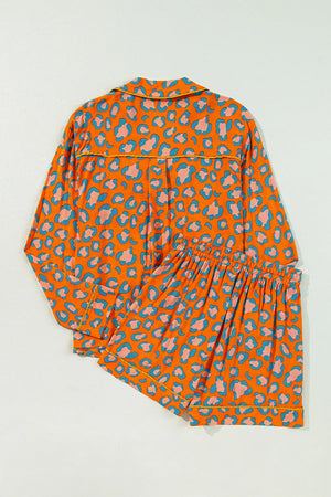 Orange leopard print satin pajama set with collared top and shorts.