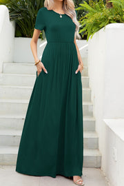 Forest green gathered waist maxi dress with short sleeves and pockets.