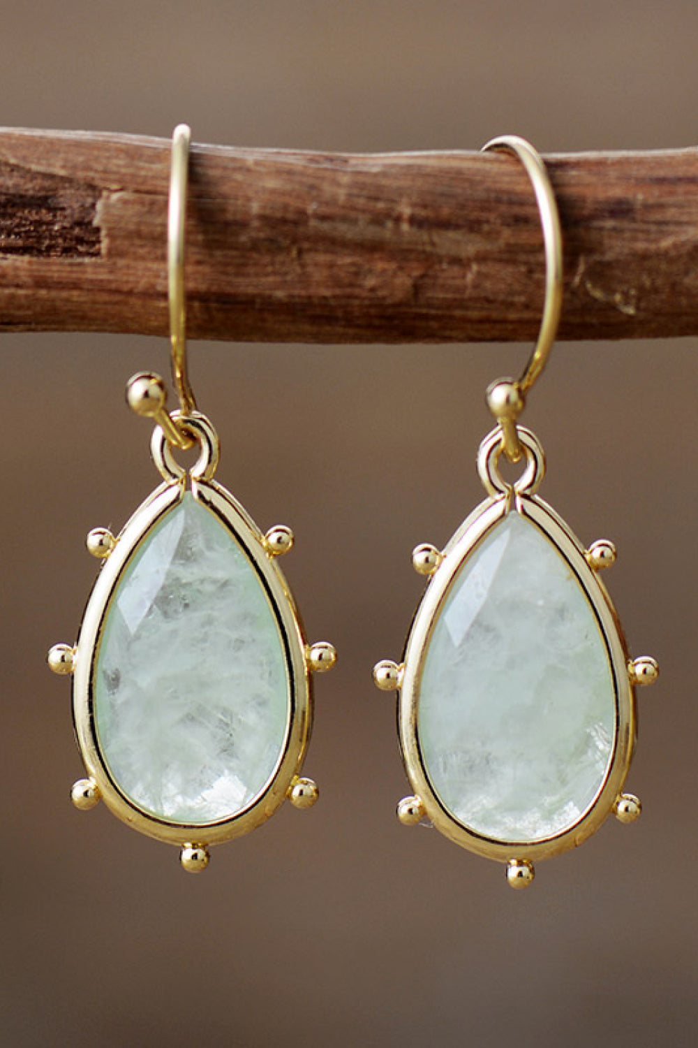 Light green teardrop amethyst earrings with gold detailing and beaded accents.