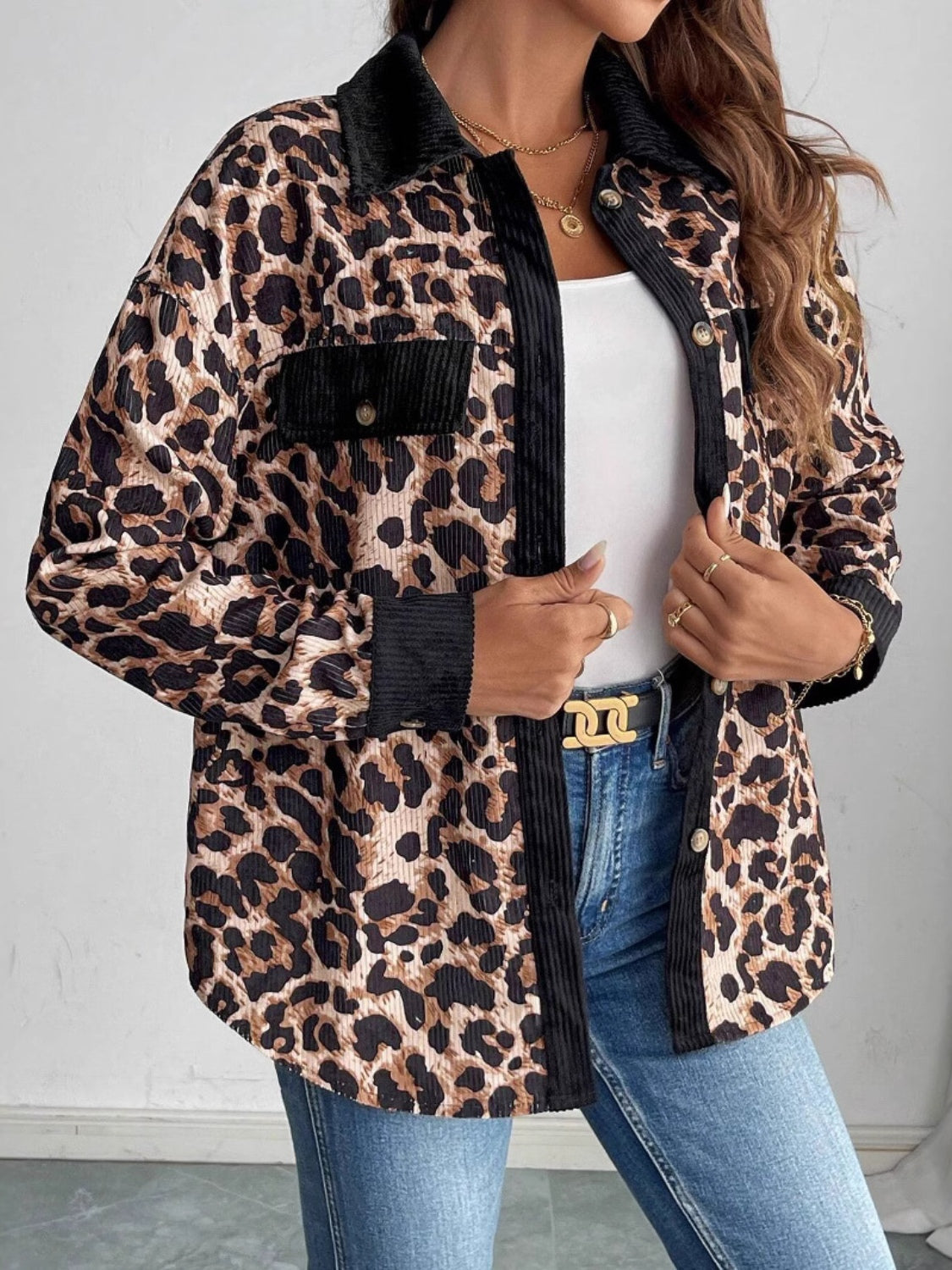 Leopard corduroy utility shirt jacket with black accents and button front.