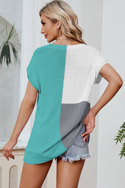 Split-tone knit tee with dolman sleeves in aqua, white, and gray.
