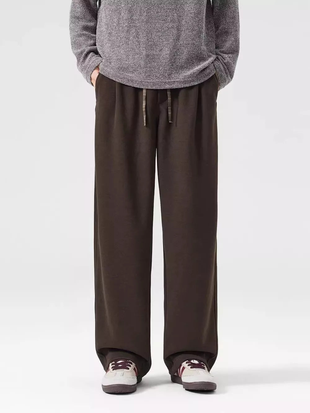 Men's brown loose-fit casual sweatpants with drawstring waist and pockets.