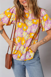 Puff sleeve blouse with ruffle trim and a colorful floral print.