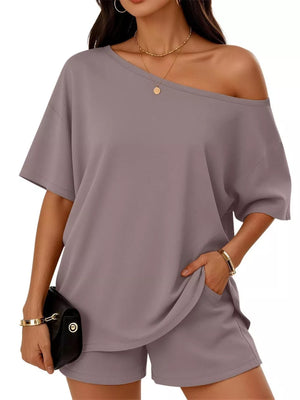 Gray boat neck tee and shorts set with pockets, styled with a clutch and jewelry.