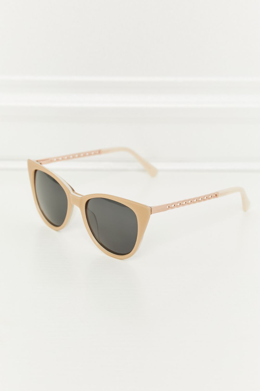 Cat-eye acetate sunglasses in mocha with chain detail on the temples.
