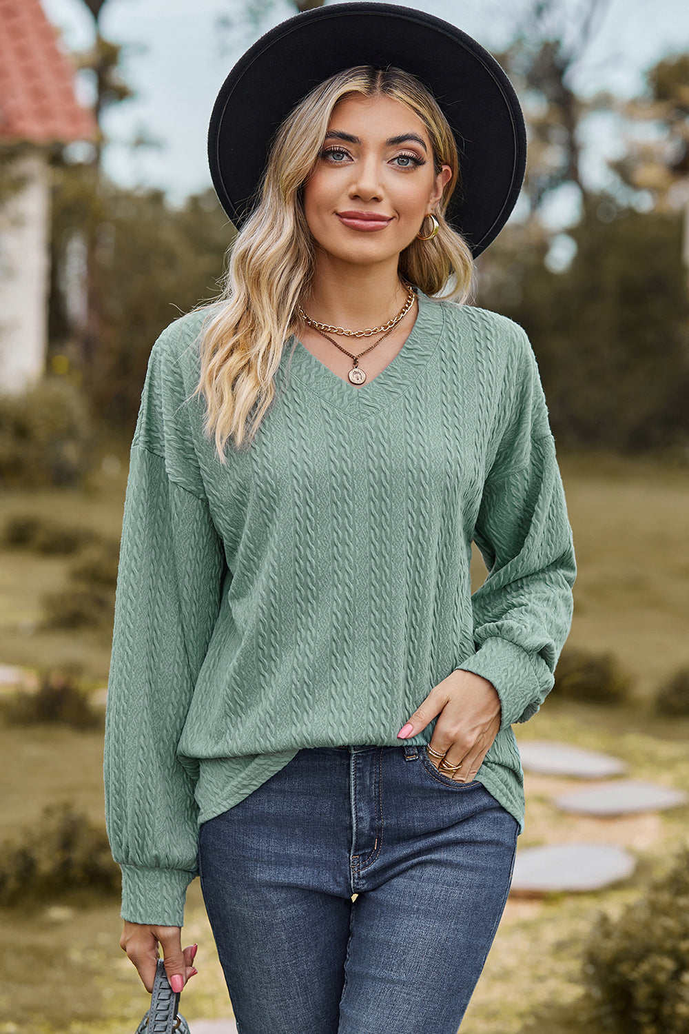 Light Green textured cable knit V-neck pullover sweater with long sleeves.