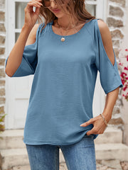 Light blue textured open-shoulder raglan blouse with short sleeves.