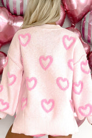Pink knit sweater with allover heart appliqué and balloon sleeves.