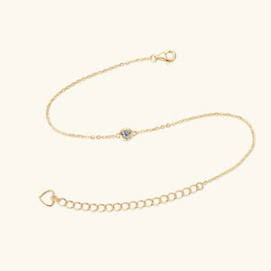 Gold moissanite solitaire chain bracelet with heart charm and adjustable clasp.