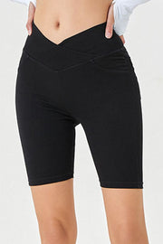 Black denim bermuda shorts with a crisscross waistband and mid-thigh length.