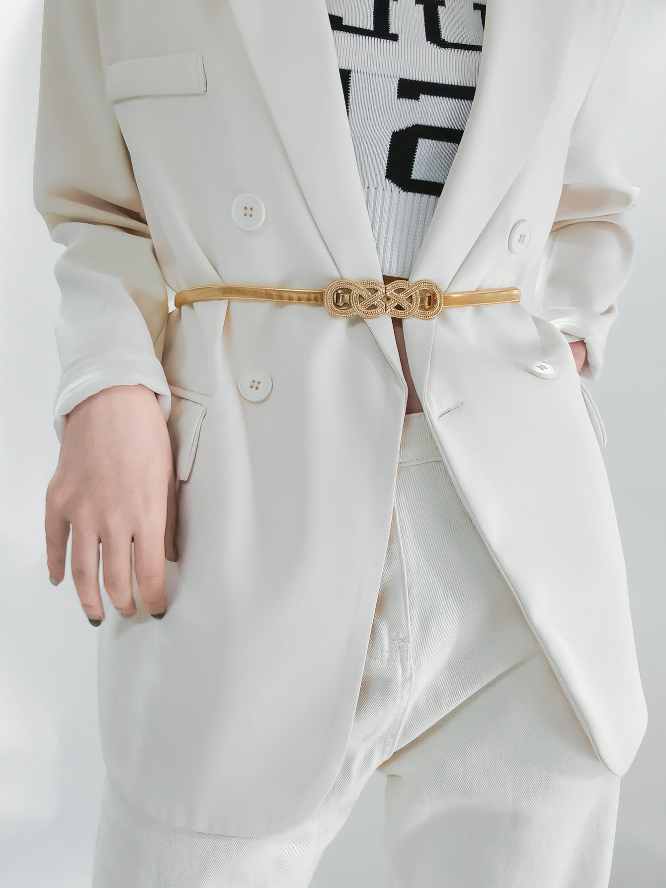 Gold intertwined knot elastic waist belt with a textured buckle detail.