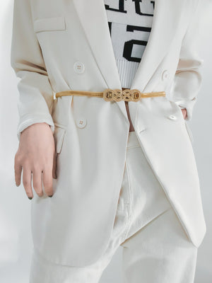 Gold intertwined knot elastic waist belt with a textured buckle detail.