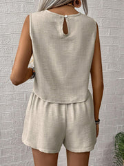 Beige textured linen tank top with keyhole back and elastic waist shorts set.