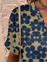 Americana Henley Print Top in blue with yellow floral pattern, short sleeves, and V-neck.