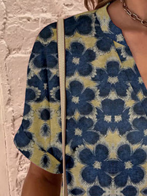 Americana Henley Print Top in blue with yellow floral pattern, short sleeves, and V-neck.