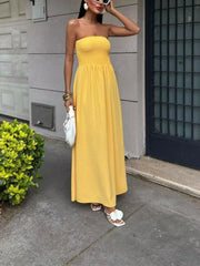 Yellow smocked bodice relaxed maxi dress with a strapless neckline.