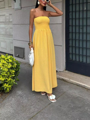 Yellow smocked bodice relaxed maxi dress with a strapless neckline.
