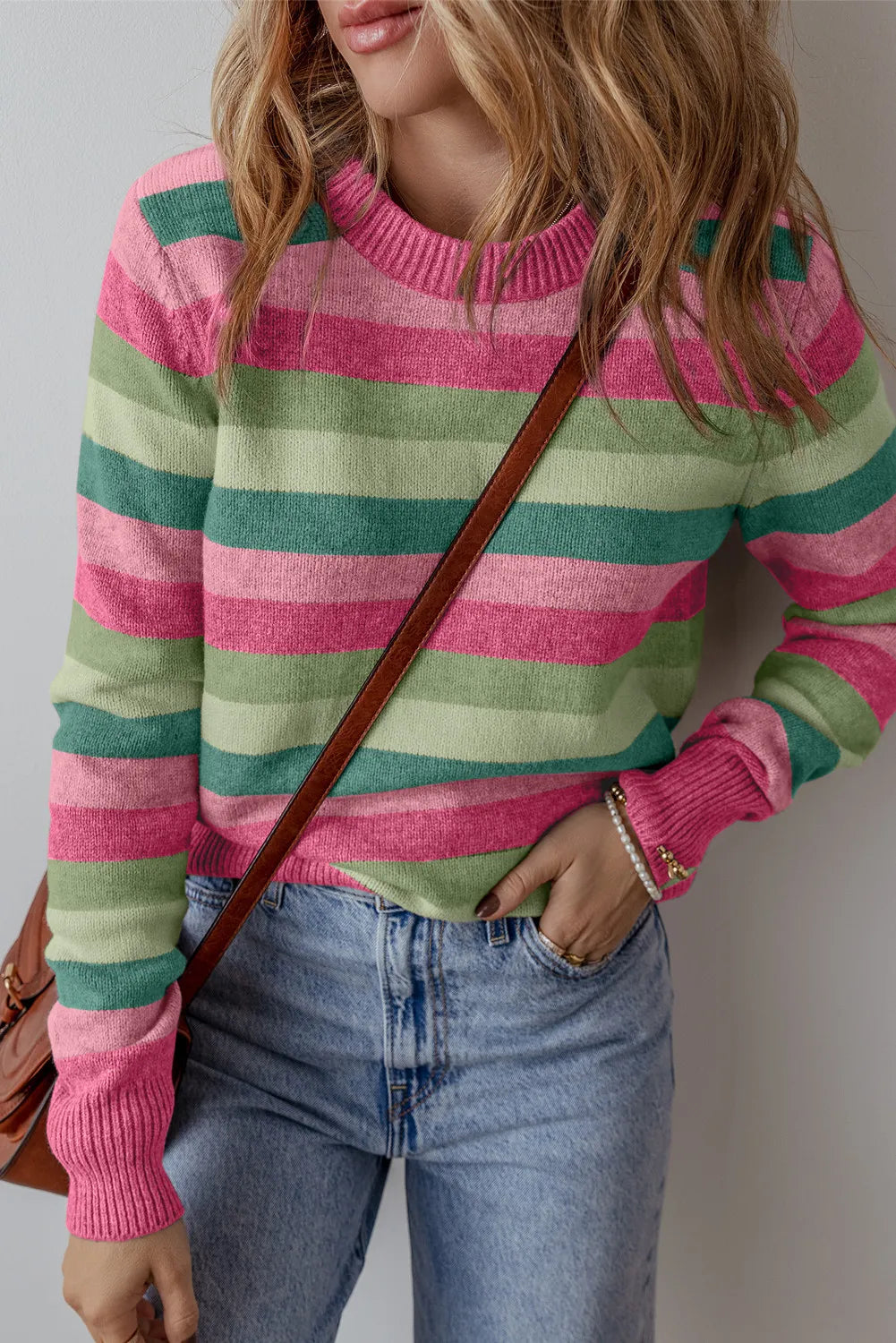 Crewneck knit sweater with pink and green stripes, ribbed cuffs and neckline.
