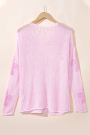 Blush pink openwork sweater with floral intarsia pattern on sleeves, acrylic knit.