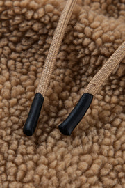 Brown sherpa hooded jacket detail with tan drawstrings and black tips.