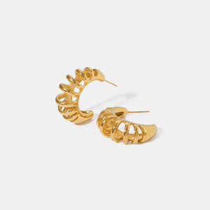 Gold sculptural ribbed hoop earrings with a modern, chic design.
